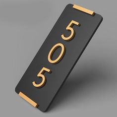 a black and gold house number sign on a gray background with the number fifty five