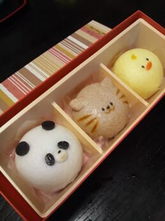 three different types of food in a box on a table with a rubber ducky