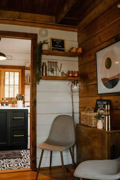 a chair and table in a room with wood paneling on the wall behind it