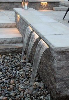 an outdoor fountain with water flowing from it