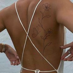 the back of a woman's body with flowers on it