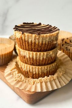 three cupcakes stacked on top of each other with chocolate frosting and peanut butter