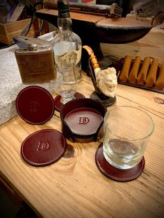 a wooden table topped with glasses and plates