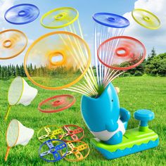 an image of a blue whale playing in the grass with lots of different toy items