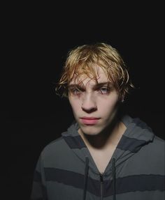 a young man with blonde hair wearing a hoodie