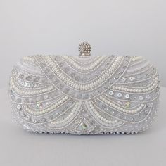 This sophisticated bridal clutch never fails to turn heads with its understated elegance and classic design. Adorned with creamy pearls and set with an array of sparkling sequins, this bridal clutch is the very picture of refinement. The crystal clasp and intricately encrusted front give this bridal clutch the look and feel of opulence and at the back of the clutch has the feel of smooth, soft satin. Available with a detachable long, metal shoulder chain, you can either drape your bridal clutch White Couture, Fancy Clutch, Bridal Clutch Bag, Beaded Clutch Purse, Pearl Clutch, Wedding Bags, Crystal Bags, Crystal Clutch, Wedding Clutch