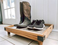 two pairs of shoes sitting on top of a wooden platform in front of a door