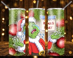 three christmas themed tumblers with santa clause on them