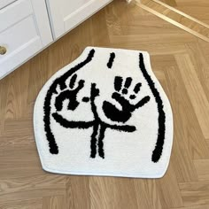 a white rug with black hand prints on it