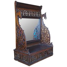 an ornate wooden mirror and shelf on white background