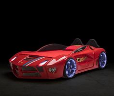 a red sports car is shown with blue lights on the front and back wheels,