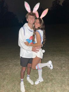 a man and woman in bunny ears hugging each other