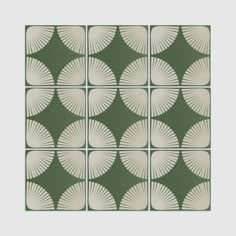 a green and white tile design with large leaves on the back side, in squares