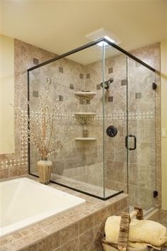 a bathroom with a walk in shower next to a bath tub