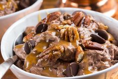 a bowl filled with chocolate pudding and pecans