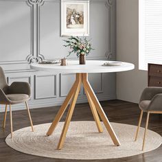 a white table with two chairs around it