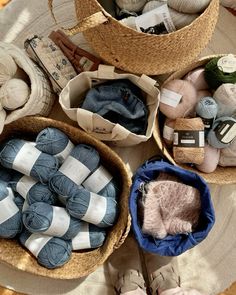 several baskets filled with yarn and knitting supplies