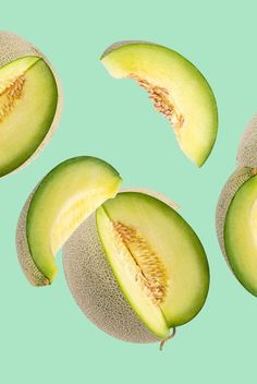 four pieces of avocado cut in half on a blue and green colored background