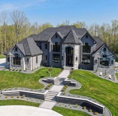 this is an aerial view of a house in the country side with stone and brick accents