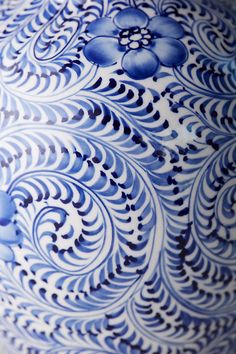 an ornate blue and white vase is shown in close up view with the design on it