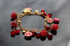 High quality non tarnish handmade jewelry  Legend has it that raspberries are originally a white fruit. The nymph Ida, daughter of the King of Crete and nurse of Zeus, wanted to pick a raspberry to calm his sorrow. She pricked her breast with the raspberry thorns and the fruit then turned a blood-red color. The pomegranate was revered for the beauty of its shrub, flowers, and fruit--symbolizing sanctity, fertility, and abundance. The Song of Solomon compares the cheeks of a bride behind her veil Pink Fruit Design Jewelry, Pomegranate Jewelry Handmade, Cute Berry-colored Jewelry With Fruit Design, Raspberry Jewelry, Gold Pomegranate Necklace, Pomegranate Pendant, Blood Red Color, White Fruit, Daughter Of The King