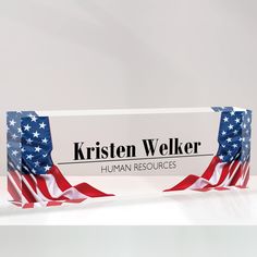 a sign with the words kristen welker on it and an american flag