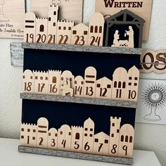 wooden blocks with numbers on them are displayed in front of a white wall and black background