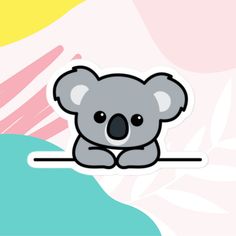 a koala sticker sitting on top of a blue and yellow background with leaves