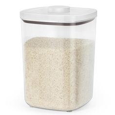 a plastic container filled with rice on top of a white table