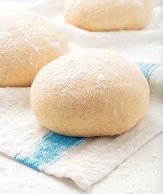 three uncooked bread rolls on a towel