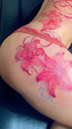 a woman's thigh with pink flowers painted on it