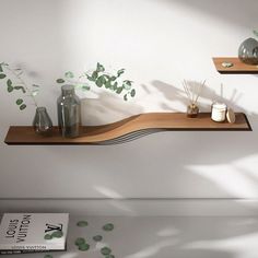 two shelves with plants and vases on them