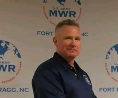 a man standing in front of a wall with the words fort wayne written on it