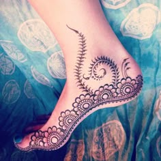 a woman's foot with hennap on it, and an intricate design