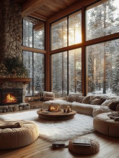 a living room filled with lots of furniture next to a fire place and large windows