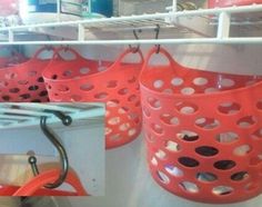 red baskets are hanging on the shelves in a store, and one is holding an umbrella