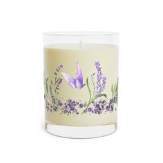 a white candle with purple flowers and leaves painted on the inside, sitting in front of a white background