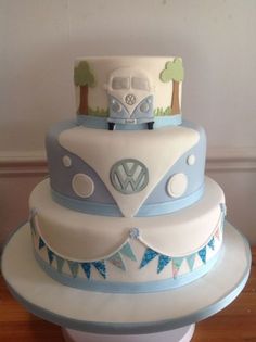 a three tiered cake with a vw camper on the top and bunting