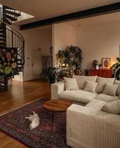 a living room filled with furniture and a spiral staircase