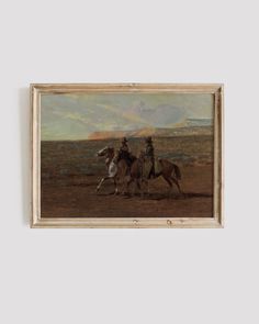 two men riding horses in an open field