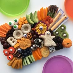 a platter filled with lots of different types of food on top of a table