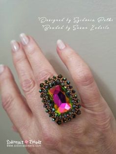 a woman's hand with a ring made out of beads