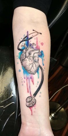 a heart with a stethoscope tattoo on the arm