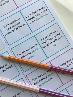 two pencils sitting on top of a piece of paper with words written in it