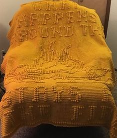 a yellow blanket sitting on top of a bed