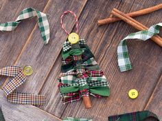 a christmas tree made out of fabric and buttons on a wooden table with other items