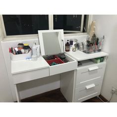 a white desk with drawers and a mirror