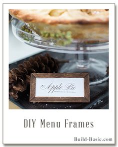 an apple pie sitting on top of a table next to a sign that says diy menu frames