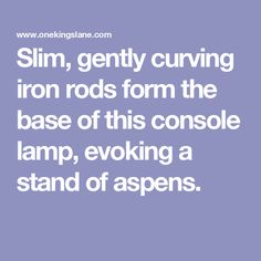 the words slim, gently curving iron rods form the base of this console lamp, evoking a stand of aspens