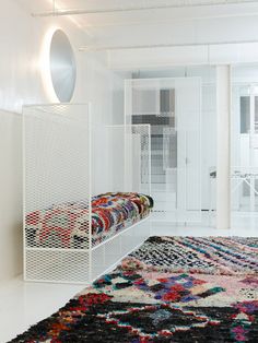 a white room with an area rug on the floor